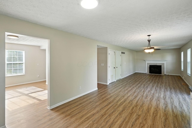 1771 Fern Trail Dr, Lancaster, OH 43130 - unfurnished living room featuring wood finished floors, a textured ceiling, and a fireplace
