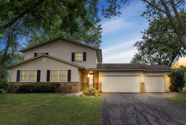 1539 Clubview Blvd S, Columbus, OH 43235 - view of front of property featuring brick siding, asphalt driveway, a garage, and a front lawn