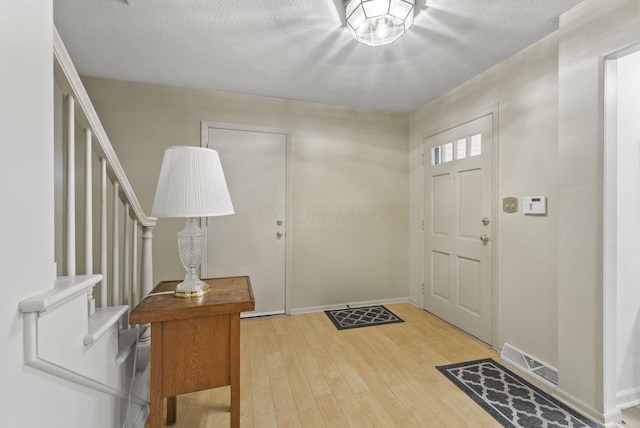 1539 Clubview Blvd S, Columbus, OH 43235 - foyer entrance with stairs, hardwood / wood-style floors, and a textured ceiling