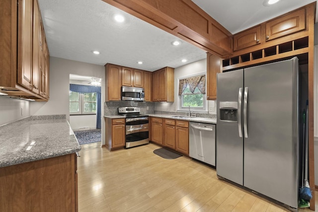 1539 Clubview Blvd S, Columbus, OH 43235 - kitchen with stainless steel appliances, plenty of natural light, brown cabinets, backsplash, and recessed lighting
