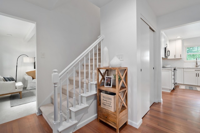 6853 Cedar Brook Pl, New Albany, OH 43054 - stairs featuring hardwood / wood-style floors