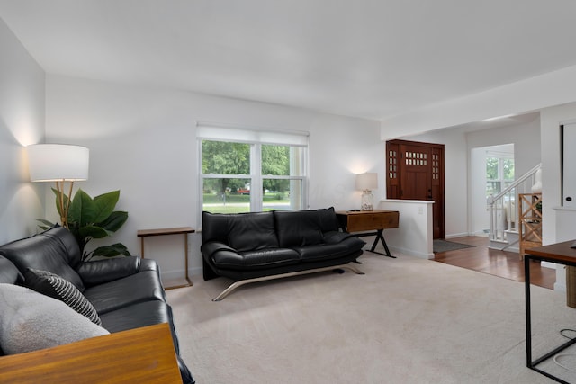 6853 Cedar Brook Pl, New Albany, OH 43054 - carpeted living room featuring plenty of natural light and stairs