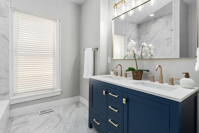 994 Harrison Ave, Columbus, OH 43201 - bathroom with marble look tiles, double vanity, and plenty of natural light
