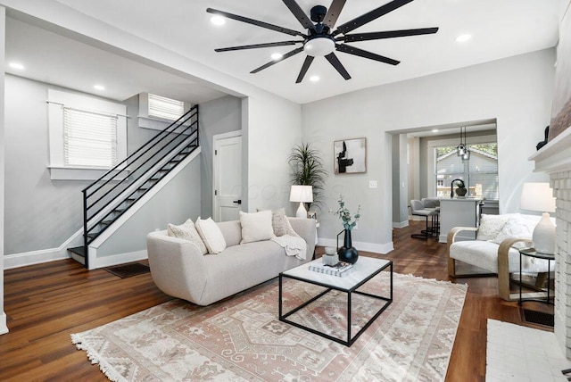 994 Harrison Ave, Columbus, OH 43201 - living room featuring ceiling fan, stairs, wood finished floors, a brick fireplace, and recessed lighting