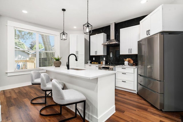 994 Harrison Ave, Columbus, OH 43201 - kitchen featuring freestanding refrigerator, wall chimney exhaust hood, tasteful backsplash, recessed lighting, and dark wood finished floors
