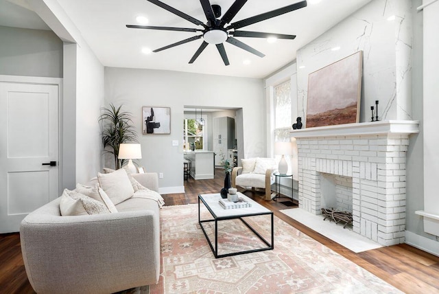 994 Harrison Ave, Columbus, OH 43201 - living room with ceiling fan, wood finished floors, a brick fireplace, and recessed lighting