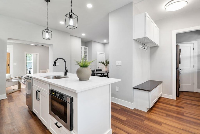 994 Harrison Ave, Columbus, OH 43201 - kitchen with stainless steel appliances, dark wood-style flooring, white cabinets, hanging light fixtures, and recessed lighting