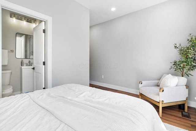 994 Harrison Ave, Columbus, OH 43201 - bedroom with dark wood-style floors, connected bathroom, and recessed lighting