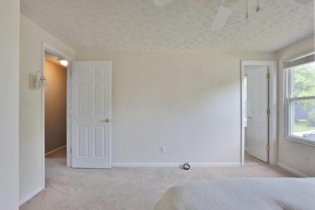 2253 Otter Ln, Dublin, OH 43016 - unfurnished bedroom with light carpet, a textured ceiling, and ceiling fan