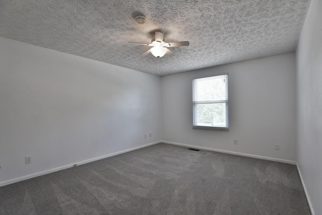2253 Otter Ln, Dublin, OH 43016 - spare room featuring a ceiling fan, dark carpet, a textured ceiling, and a smoke detector
