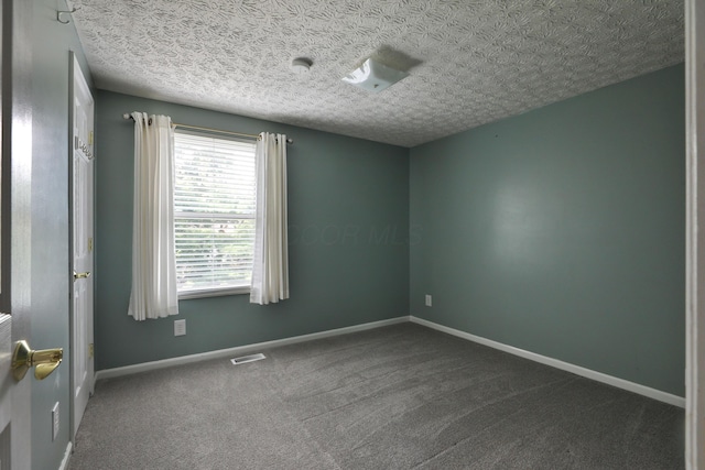 2253 Otter Ln, Dublin, OH 43016 - unfurnished room featuring dark colored carpet and a textured ceiling