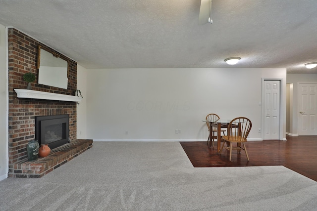 2253 Otter Ln, Dublin, OH 43016 - unfurnished dining area featuring a textured ceiling, carpet floors, and a fireplace
