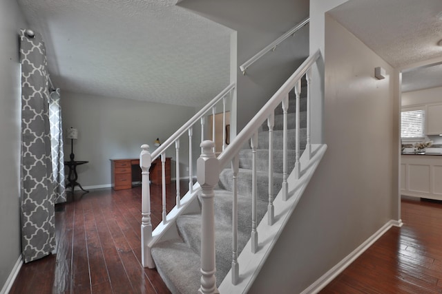 2253 Otter Ln, Dublin, OH 43016 - staircase featuring a textured ceiling and wood-type flooring