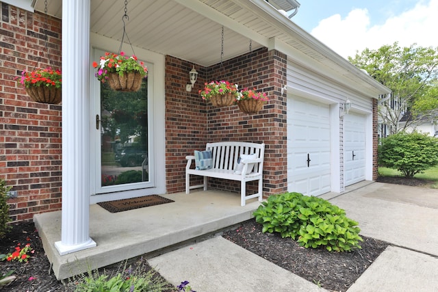 2253 Otter Ln, Dublin, OH 43016 - property entrance featuring brick siding, covered porch, driveway, and an attached garage