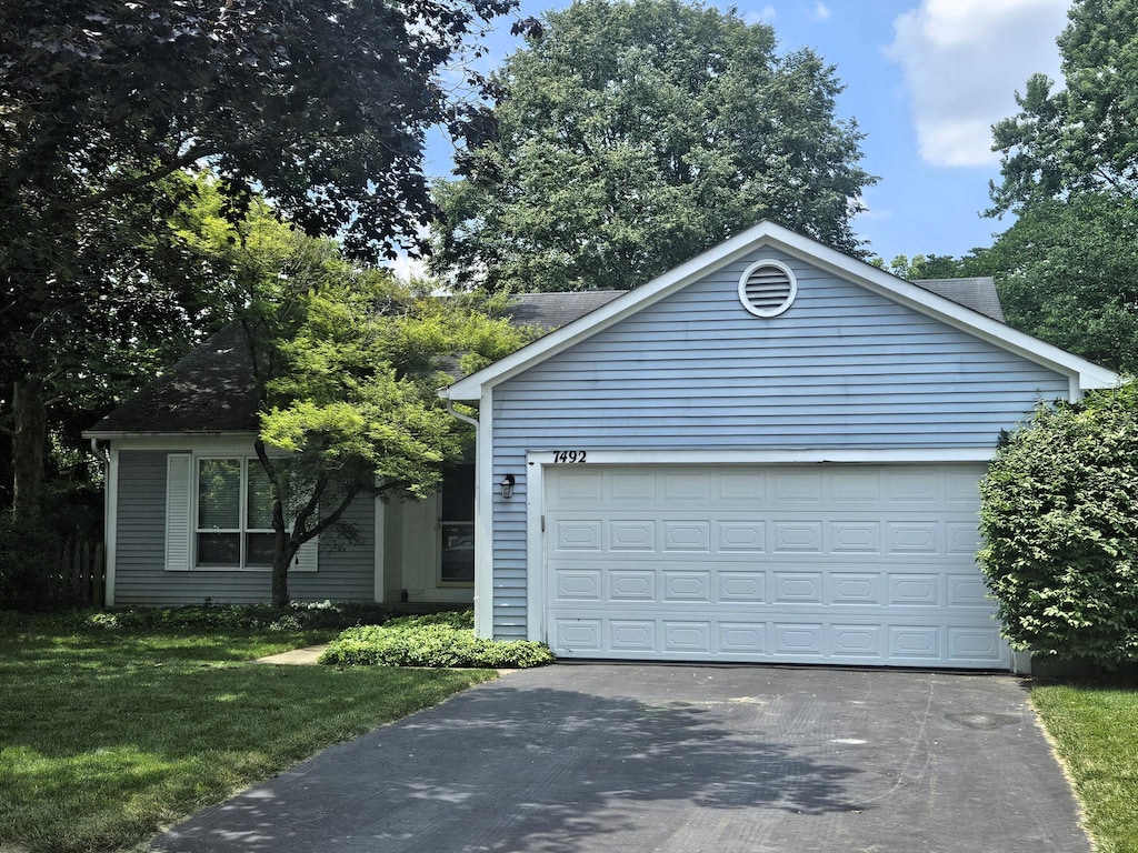 7492 Sagewood Ct, Columbus, OH 43235 - single story home with asphalt driveway, a front lawn, and a garage