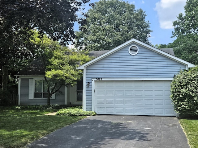 7492 Sagewood Ct, Columbus, OH 43235 - single story home with asphalt driveway, a front lawn, and a garage