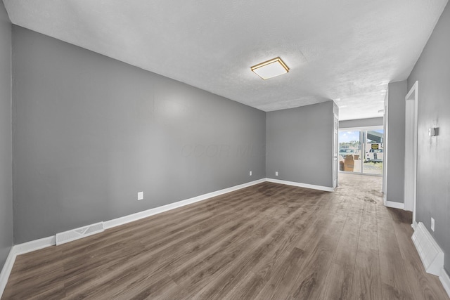 3654 Arnelle Rd, Columbus, OH 43228 - spare room featuring dark wood-style floors and a textured ceiling