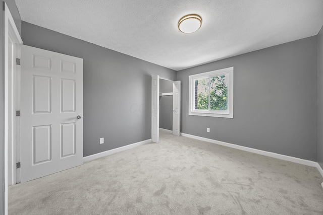 3654 Arnelle Rd, Columbus, OH 43228 - unfurnished bedroom featuring carpet, a textured ceiling, and a closet