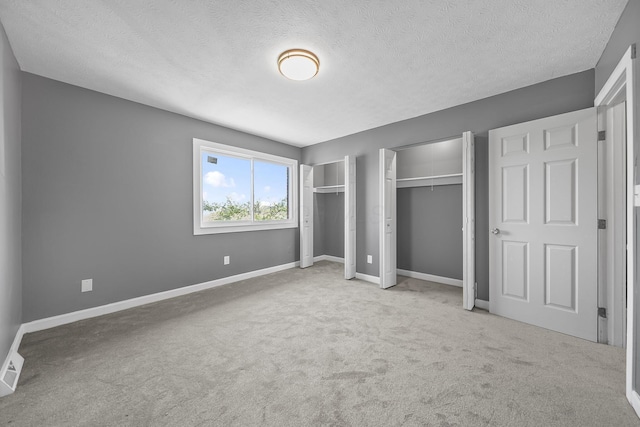 3654 Arnelle Rd, Columbus, OH 43228 - unfurnished bedroom featuring multiple closets, carpet, and a textured ceiling