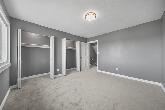 3654 Arnelle Rd, Columbus, OH 43228 - unfurnished bedroom featuring two closets and carpet flooring