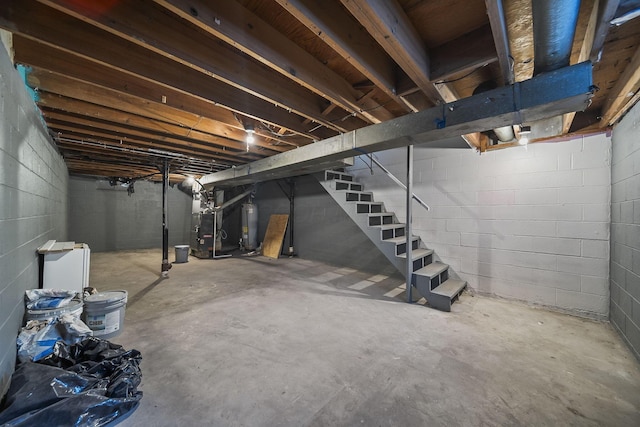 3654 Arnelle Rd, Columbus, OH 43228 - unfinished basement with gas water heater, heating unit, and stairs