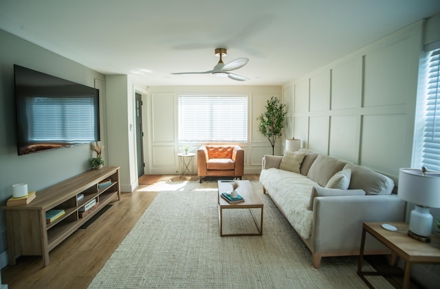 853 Thurman Ave, Columbus, OH 43206 - living room featuring wood finished floors, ceiling fan, and a decorative wall