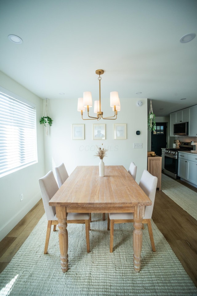 853 Thurman Ave, Columbus, OH 43206 - dining area featuring wood finished floors, a chandelier, and recessed lighting
