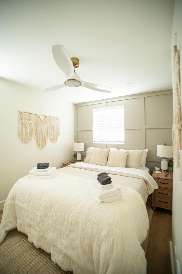 853 Thurman Ave, Columbus, OH 43206 - bedroom with a decorative wall, a ceiling fan, and dark wood finished floors
