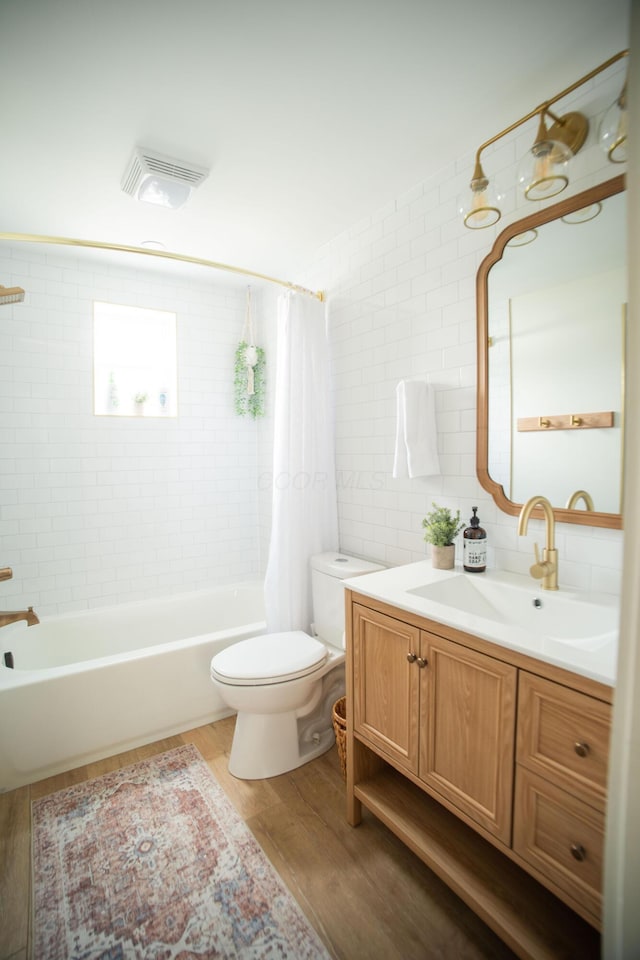 853 Thurman Ave, Columbus, OH 43206 - bathroom with wood finished floors, vanity, shower / bath combo, and tile walls