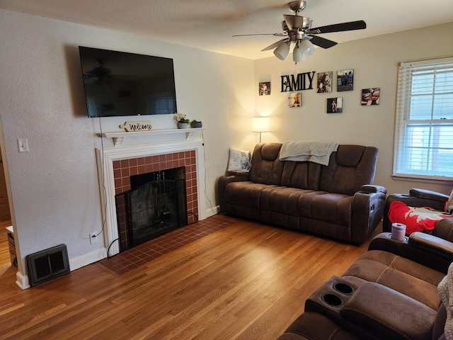 850 Grafton Rd, Newark, OH 43055 - living area with wood finished floors, a ceiling fan, and a tile fireplace