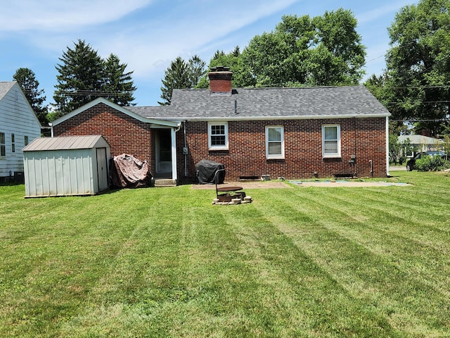 850 Grafton Rd, Newark, OH 43055 - back of property with brick siding, a storage shed, a yard, a chimney, and a shingled roof