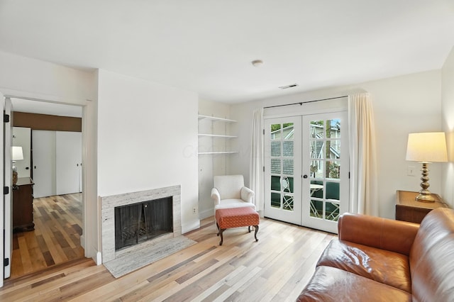 253 Kossuth St Unit H, Columbus, OH 43223 - living room featuring hardwood / wood-style floors, french doors, and a fireplace with flush hearth