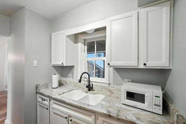 253 Kossuth St Unit H, Columbus, OH 43223 - kitchen featuring white microwave, white cabinets, and light stone countertops