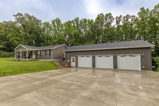 19366 Laurel Run Rd, Nelsonville, OH 45764 - ranch-style house featuring a front yard, view of wooded area, and a detached garage