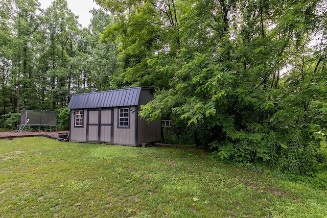 19366 Laurel Run Rd, Nelsonville, OH 45764 - view of green lawn featuring a trampoline and a storage unit