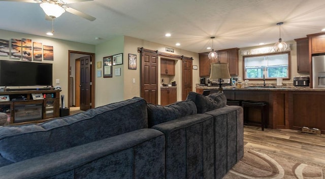 19366 Laurel Run Rd, Nelsonville, OH 45764 - living area featuring wood finished floors, a barn door, ceiling fan, and recessed lighting