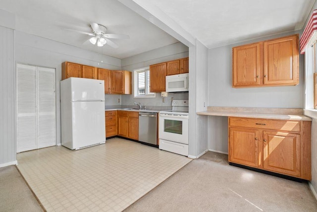 99 Maple Ave, Chillicothe, OH 45601 - kitchen with white appliances, light countertops, ceiling fan, and brown cabinetry