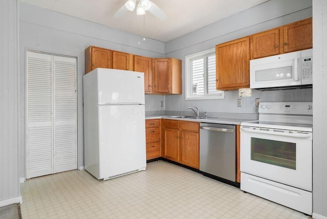 99 Maple Ave, Chillicothe, OH 45601 - kitchen with white appliances, light countertops, ceiling fan, light flooring, and brown cabinets