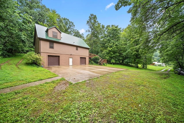 3857 US Highway 23, Chillicothe, OH 45601 - view of home's exterior with an attached garage, driveway, a yard, and a metal roof