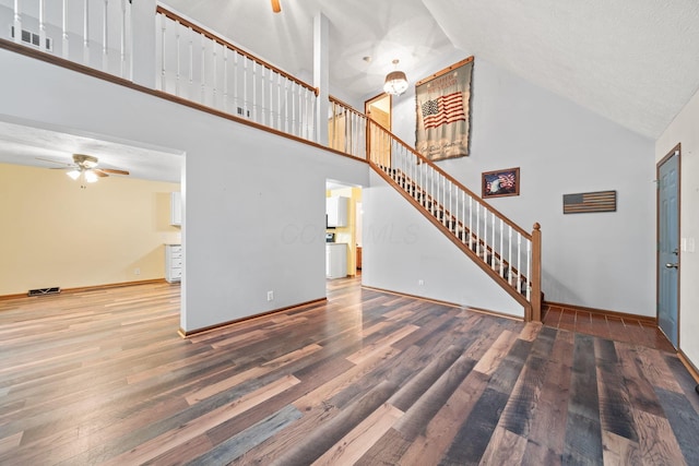 3857 US Highway 23, Chillicothe, OH 45601 - unfurnished living room featuring ceiling fan, wood finished floors, high vaulted ceiling, and stairs