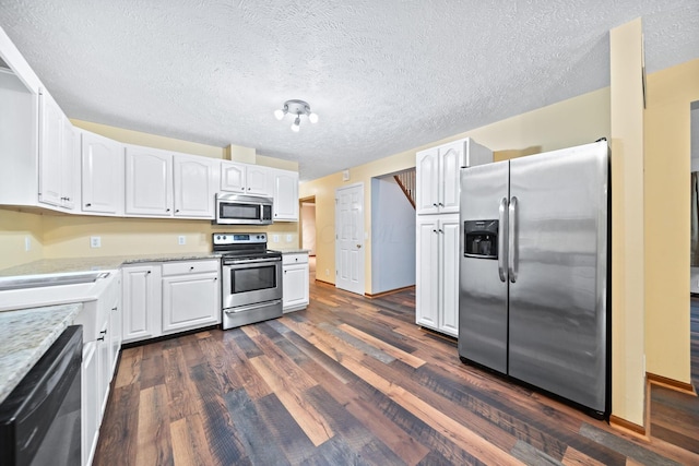 3857 US Highway 23, Chillicothe, OH 45601 - kitchen with stainless steel appliances, dark wood-type flooring, white cabinetry, and a textured ceiling