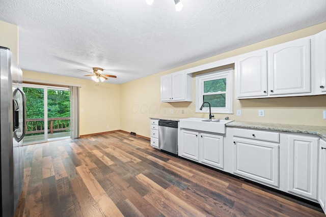 3857 US Highway 23, Chillicothe, OH 45601 - kitchen with appliances with stainless steel finishes, a ceiling fan, dark wood-type flooring, white cabinetry, and a textured ceiling