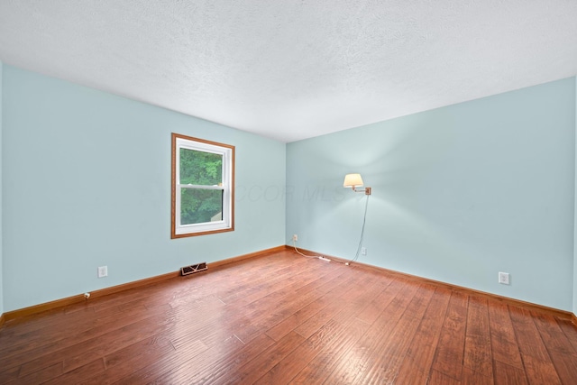 3857 US Highway 23, Chillicothe, OH 45601 - empty room with hardwood / wood-style flooring and a textured ceiling
