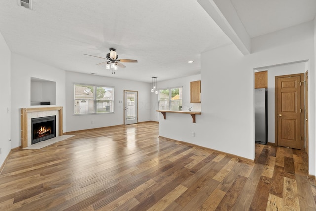 3734 Gibbstone Dr, Columbus, OH 43204 - unfurnished living room with a ceiling fan, a tile fireplace, light wood-type flooring, and recessed lighting