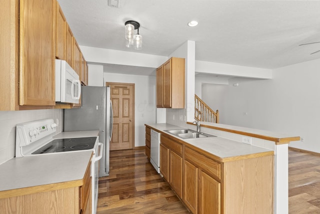 3734 Gibbstone Dr, Columbus, OH 43204 - kitchen featuring white appliances, a peninsula, wood finished floors, decorative backsplash, and light countertops