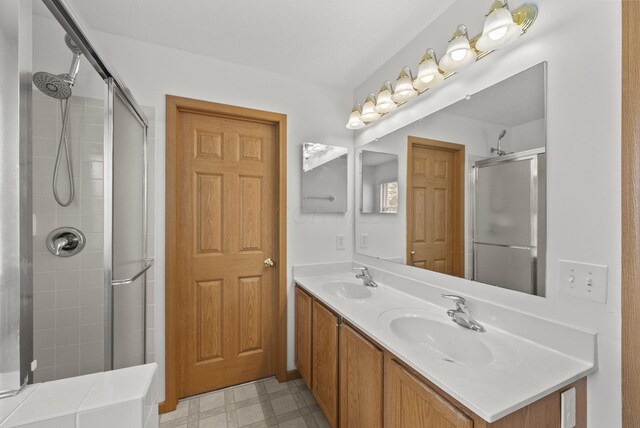 3734 Gibbstone Dr, Columbus, OH 43204 - bathroom with a tile shower, double vanity, and tile patterned floors