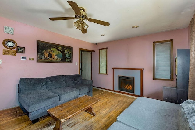 4747 Basil Ln, Cincinnati, OH 45238 - living room featuring ceiling fan, wood finished floors, and a lit fireplace