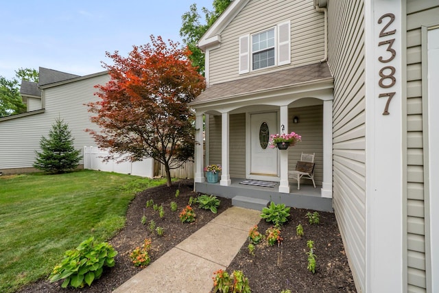2387 Sutter Pkwy, Dublin, OH 43016 - entrance to property with covered porch, a lawn, and roof with shingles