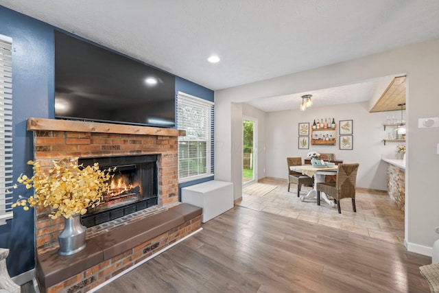 2387 Sutter Pkwy, Dublin, OH 43016 - living room with a brick fireplace, wood finished floors, and recessed lighting