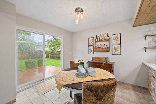 2387 Sutter Pkwy, Dublin, OH 43016 - dining space featuring a textured ceiling and a dry bar